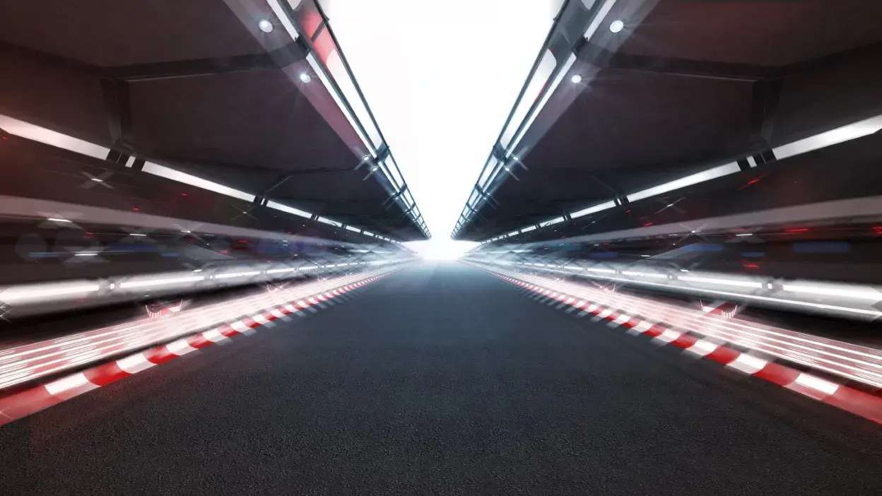 Pista de corrida futurista com luzes e efeito de movimento nas laterais.